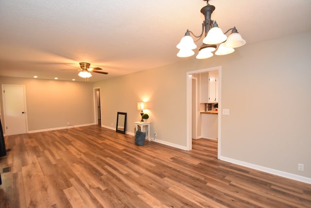 208 Pinehurst Dr, Enterprise, AL 36330 - unfurnished living room featuring wood finished floors, a chandelier, a ceiling fan, baseboards, and recessed lighting
