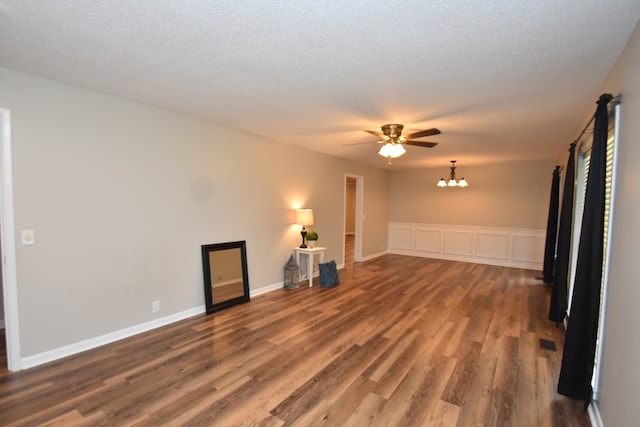 208 Pinehurst Dr, Enterprise, AL 36330 - unfurnished living room featuring wood finished floors, ceiling fan, and a chandelier