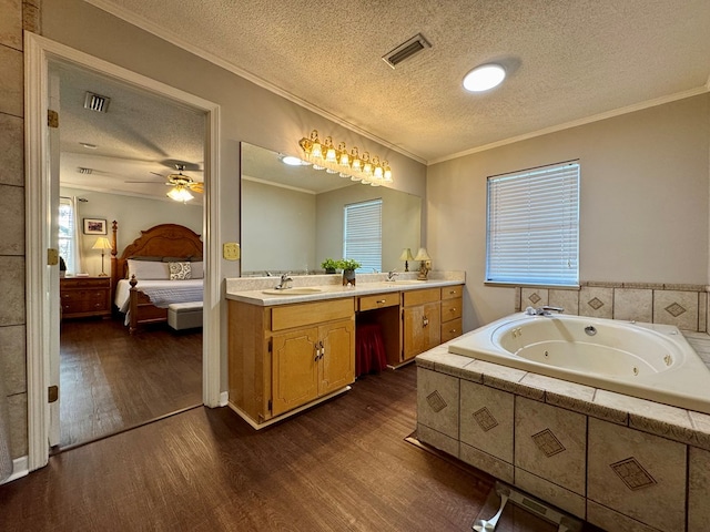 bathroom featuring vanity, a textured ceiling, ceiling fan, crown molding, and wood-type flooring