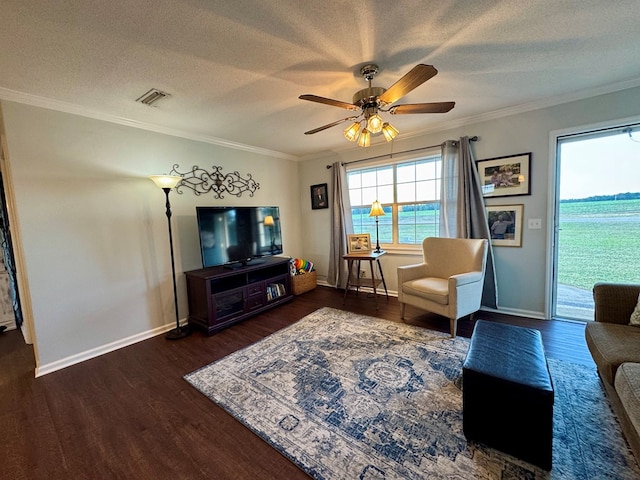 living room featuring dark hardwood / wood-style flooring, a textured ceiling, ceiling fan, and crown molding