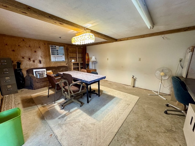 dining space featuring beamed ceiling, a textured ceiling, and concrete flooring