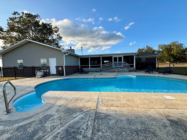 view of pool featuring a patio area and a sunroom