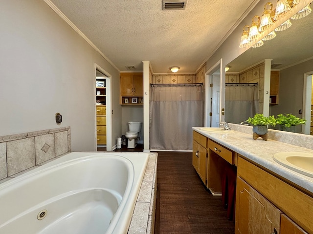 full bathroom featuring hardwood / wood-style floors, toilet, crown molding, and a textured ceiling