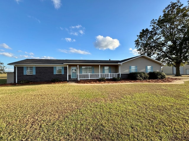 ranch-style home with covered porch and a front yard