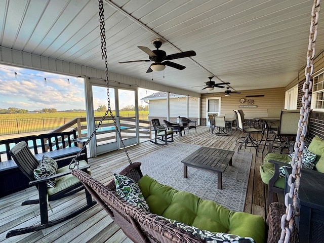 wooden deck featuring a rural view and an outdoor hangout area