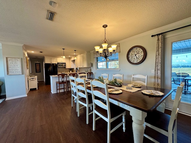 dining area with a textured ceiling, dark hardwood / wood-style floors, an inviting chandelier, and ornamental molding