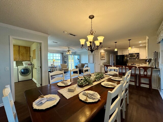 dining area with dark hardwood / wood-style flooring, independent washer and dryer, a textured ceiling, ceiling fan with notable chandelier, and ornamental molding