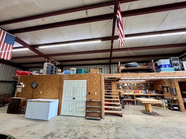 garage with a workshop area and white refrigerator