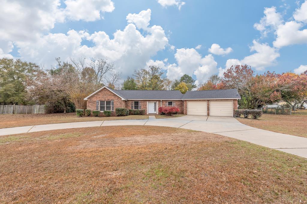 view of front of house featuring a garage and a front lawn