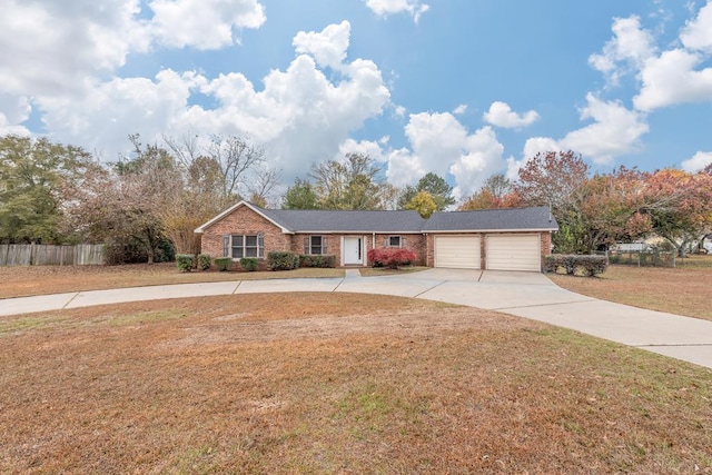 view of front of house featuring a garage and a front lawn