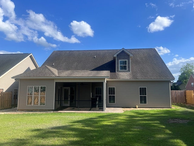 back of house featuring a patio and a lawn