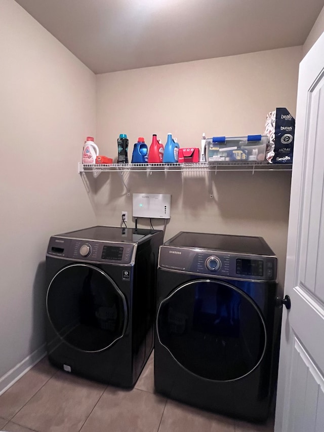 washroom with independent washer and dryer and light tile patterned floors