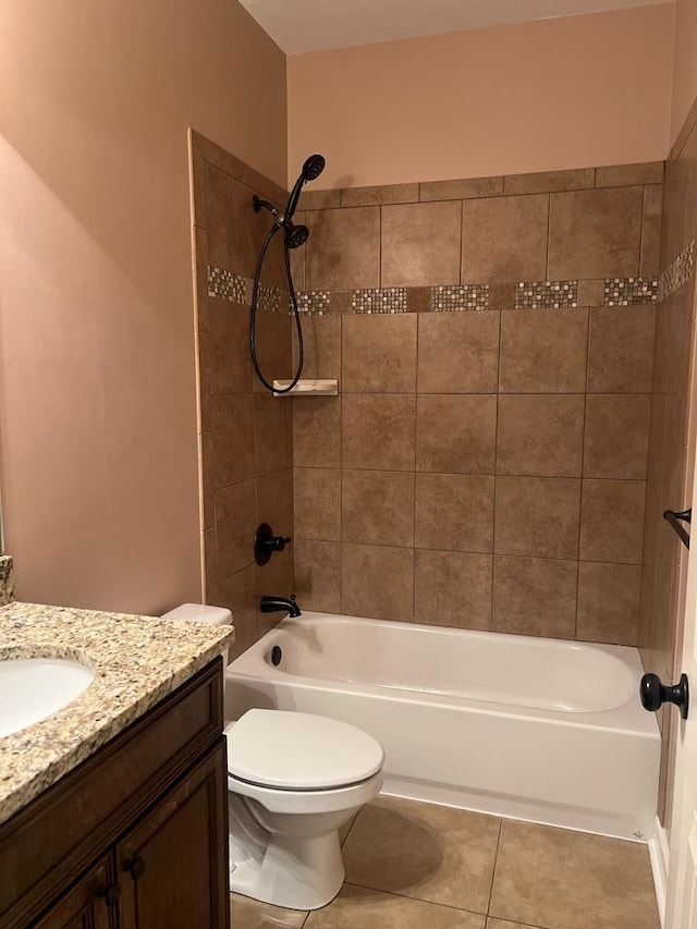 full bathroom featuring tile patterned flooring, vanity, tiled shower / bath combo, and toilet