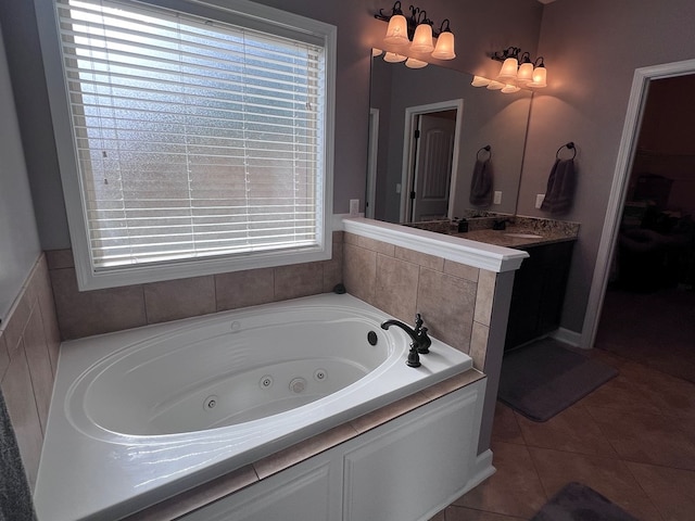 bathroom featuring tile patterned floors, plenty of natural light, a bath, and vanity