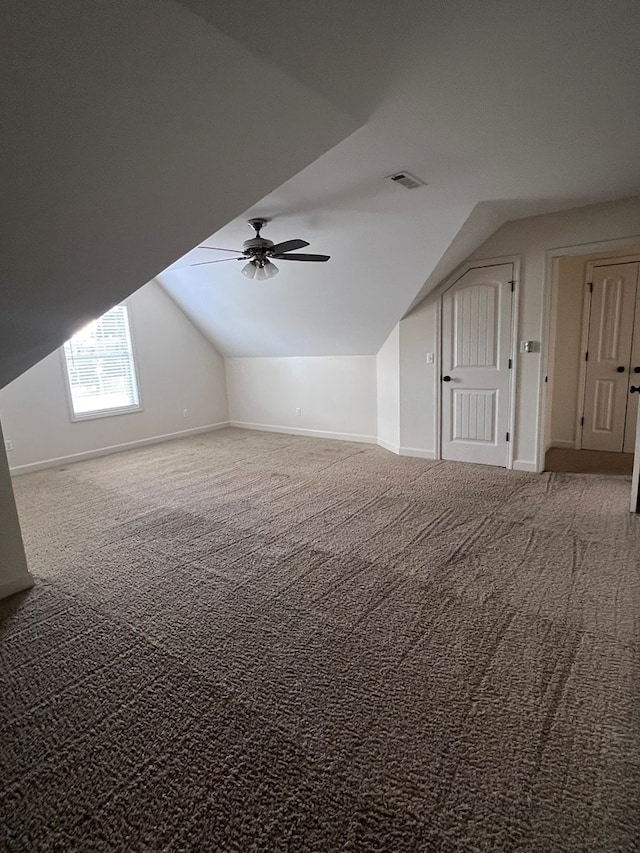 additional living space with carpet flooring, ceiling fan, and lofted ceiling