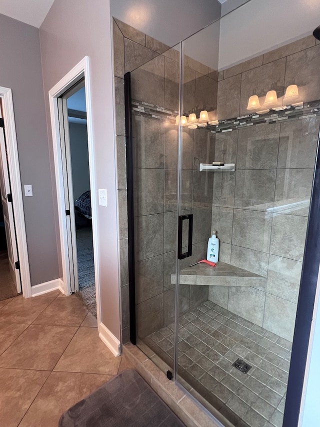 bathroom with tile patterned floors and a shower with shower door