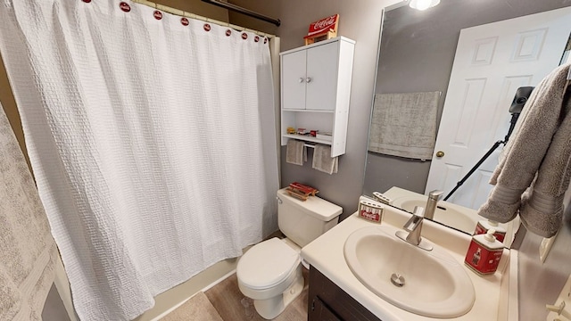 bathroom featuring toilet and vanity