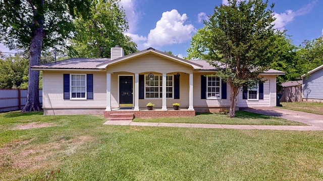 single story home featuring a chimney, covered porch, fence, metal roof, and a front lawn