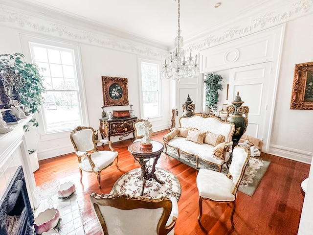 298 E Broad St, Ozark, AL 36360 - living area featuring a chandelier, ornamental molding, light wood-style flooring, a fireplace with flush hearth, and baseboards
