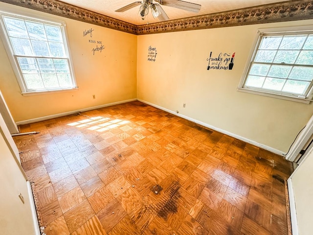 empty room featuring baseboards and a ceiling fan