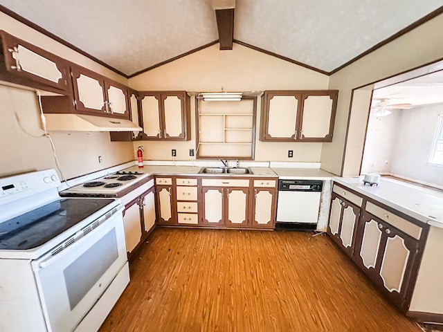 kitchen featuring white appliances, light countertops, a sink, and wood finished floors