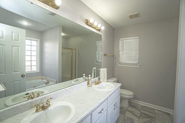 full bathroom with toilet, vanity, and separate shower and tub