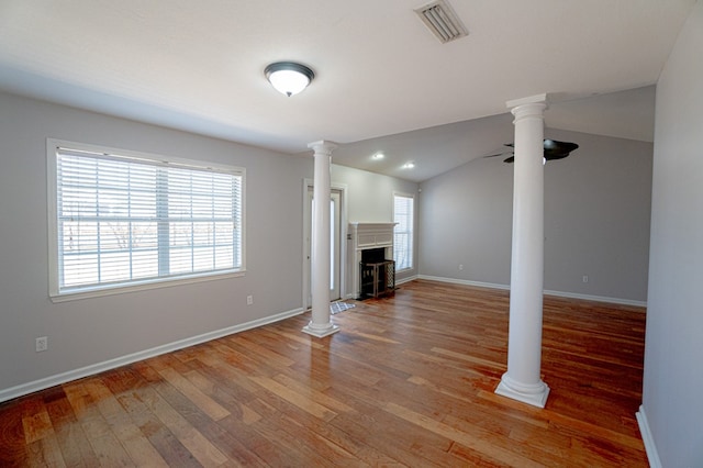 unfurnished living room with hardwood / wood-style flooring, a wealth of natural light, lofted ceiling, and ceiling fan