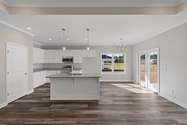 kitchen featuring a kitchen island with sink, white cabinets, dark wood-type flooring, and appliances with stainless steel finishes