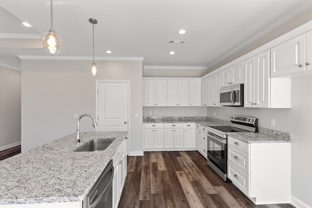 kitchen featuring light stone countertops, sink, decorative light fixtures, white cabinets, and appliances with stainless steel finishes