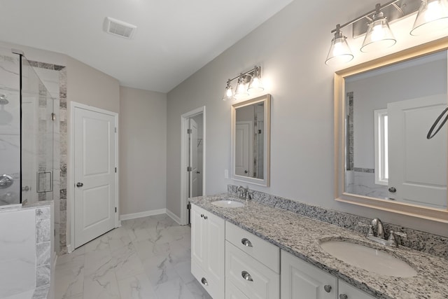 bathroom featuring vanity and a shower with shower door