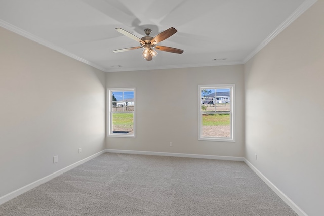 carpeted empty room featuring crown molding and ceiling fan