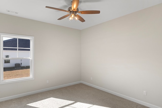 carpeted spare room with ceiling fan