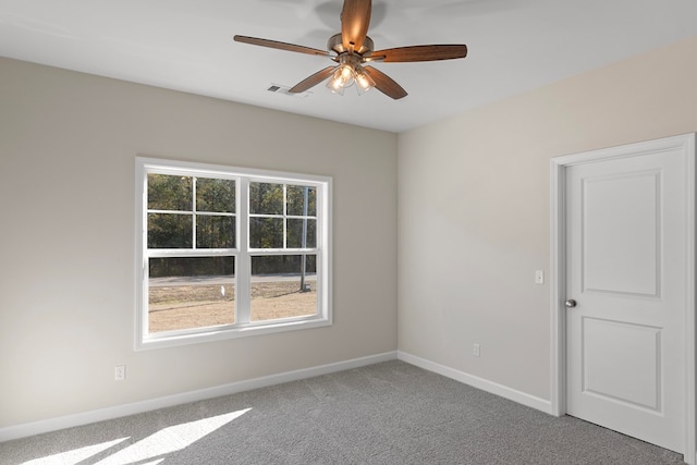 carpeted spare room with ceiling fan