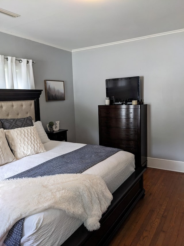 bedroom featuring dark hardwood / wood-style flooring and ornamental molding