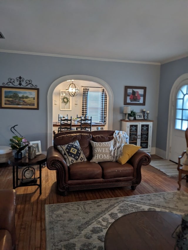 living room with hardwood / wood-style flooring and crown molding