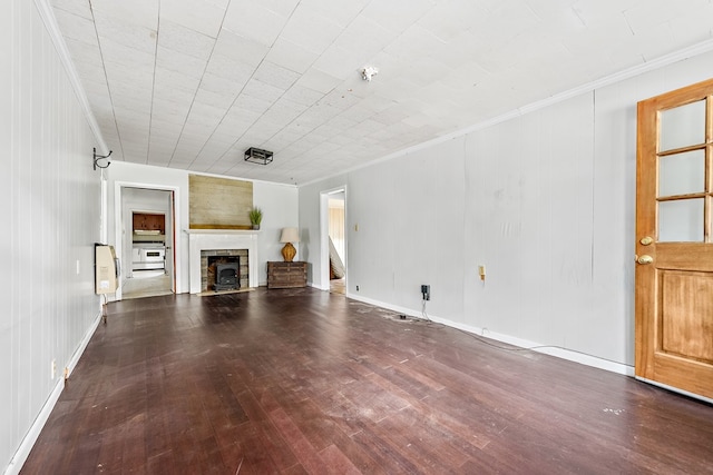 217 S S Greenwood St, Geneva, AL 36340 - unfurnished living room featuring wood-type flooring, crown molding, and a fireplace