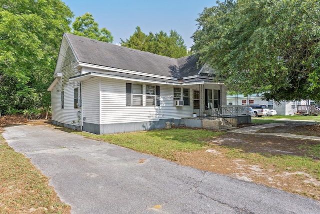 217 S S Greenwood St, Geneva, AL 36340 - view of front facade with a porch, a front lawn, driveway, and a shingled roof