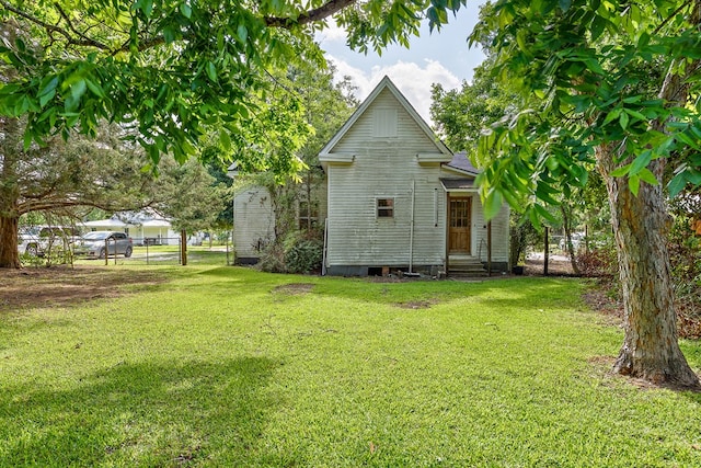 217 S S Greenwood St, Geneva, AL 36340 - back of house featuring entry steps, crawl space, and roof with shingles