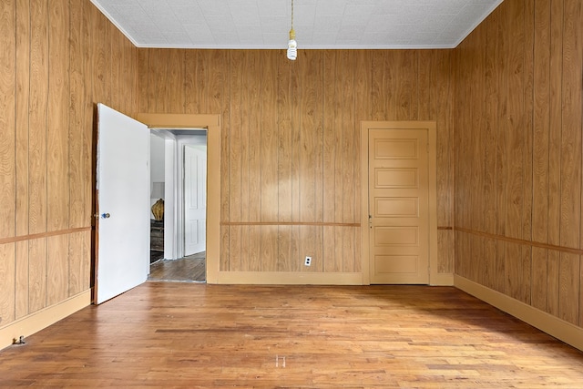 217 S S Greenwood St, Geneva, AL 36340 - empty room with wood finished floors, wooden walls, and baseboards