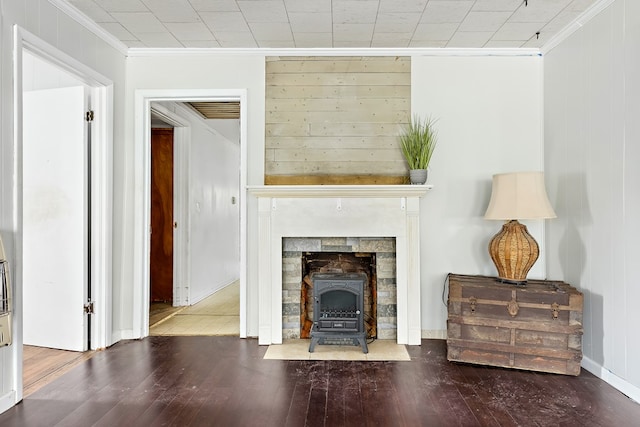 217 S S Greenwood St, Geneva, AL 36340 - living room featuring crown molding, hardwood / wood-style floors, and a wood stove