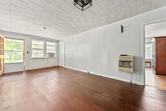 217 S S Greenwood St, Geneva, AL 36340 - unfurnished living room featuring heating unit, crown molding, dark wood-style floors, cooling unit, and baseboards