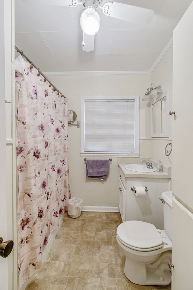 bathroom featuring vanity, toilet, walk in shower, and crown molding