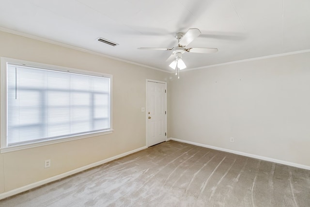 unfurnished room featuring light colored carpet, ceiling fan, and ornamental molding