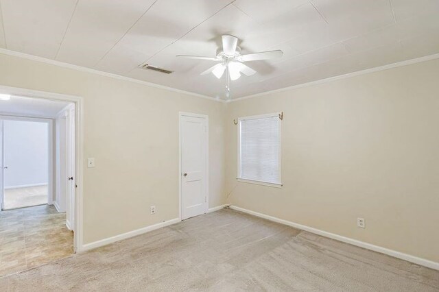 carpeted spare room featuring ceiling fan and ornamental molding