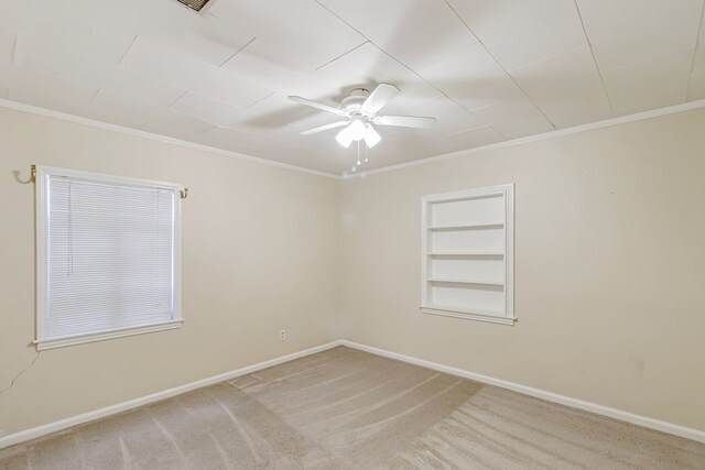 unfurnished room featuring light carpet, crown molding, and ceiling fan