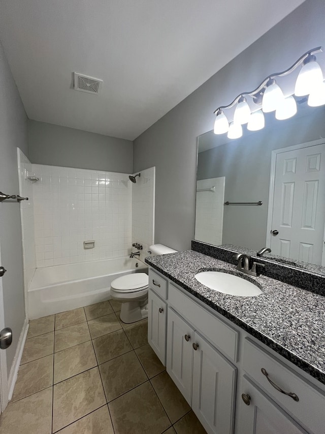 full bathroom featuring toilet, vanity, tile patterned floors, and tiled shower / bath combo