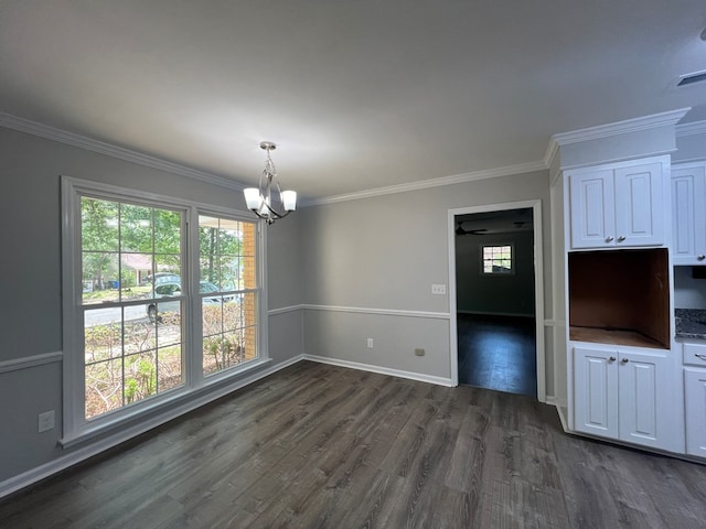 unfurnished dining area with plenty of natural light, dark hardwood / wood-style flooring, and ornamental molding