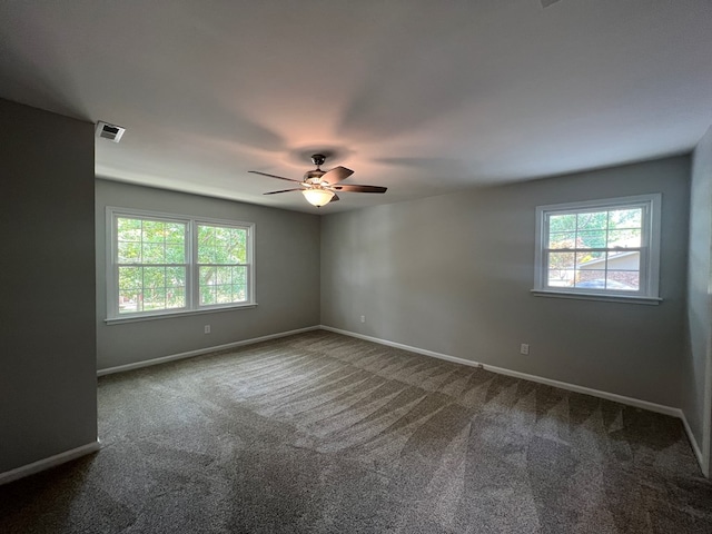 unfurnished room with carpet floors, plenty of natural light, and ceiling fan