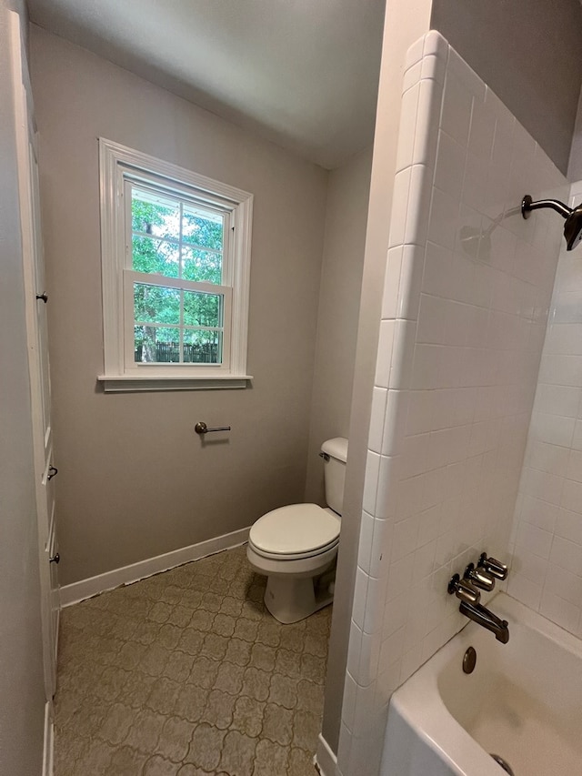 bathroom featuring washtub / shower combination and toilet