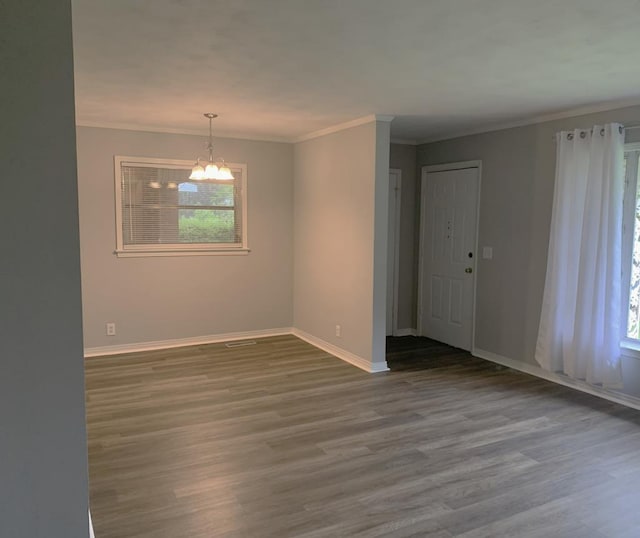 1109 Sumter St, Dothan, AL 36301 - unfurnished room with a chandelier, wood finished floors, and crown molding